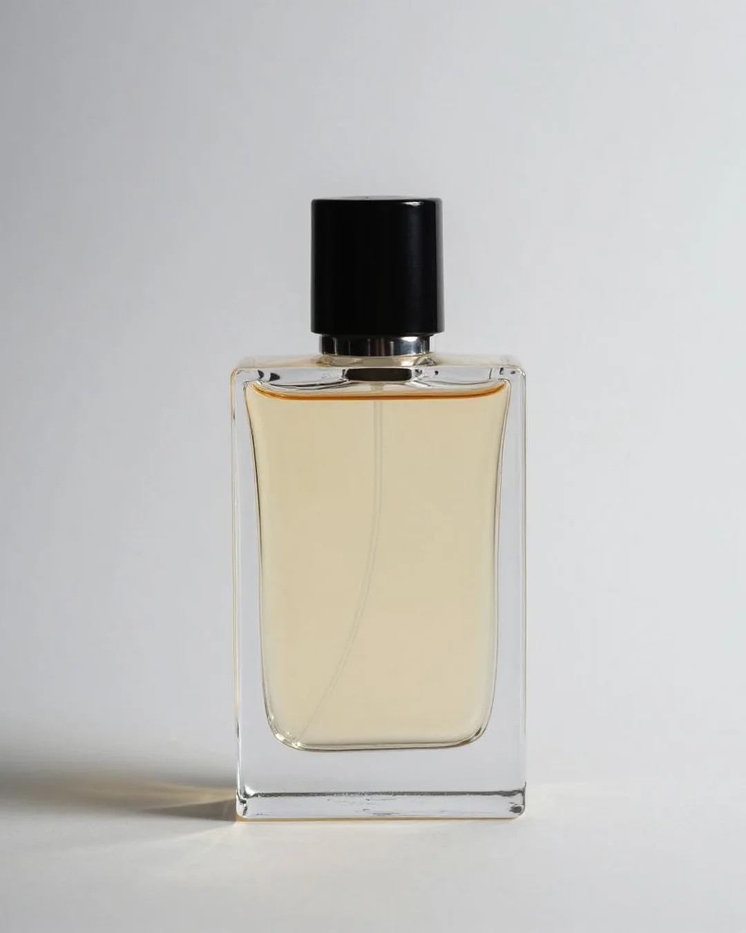 Amber perfume bottle on neutral backdrop